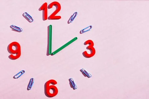 Study the topic of hours with children. The watch is made of numbers, paper c Stock Photos