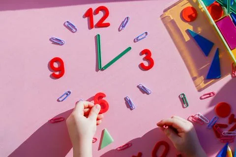 Study the topic of hours with children. The watch is made of numbers, paper c 写真素材
