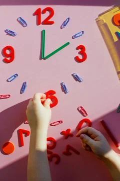 Study the topic of hours with children. The watch is made of numbers, paper c 写真素材