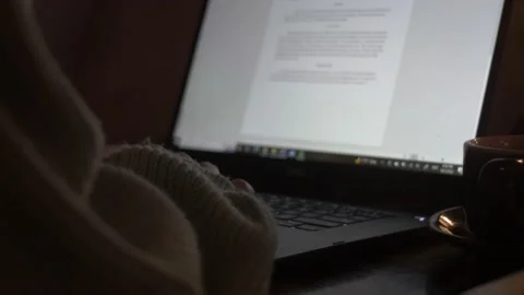 Study typing on computer in dark coffee shop at night in the evening college 4K Stock Footage 218219942