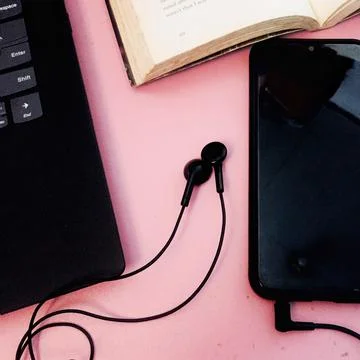 Study while listening to music from mobile phones. Stock Photos