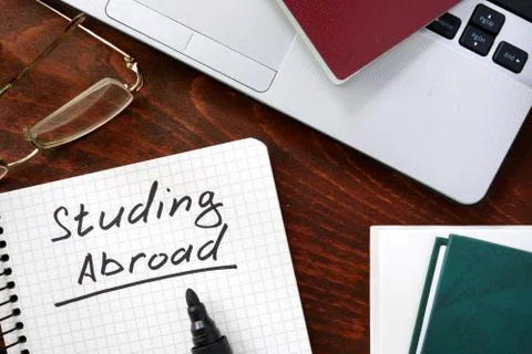 Studying Abroad concept on a paper with notebook. Stock Photos