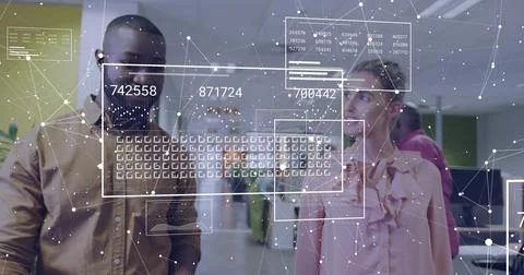 Studying AR overlay with numeric codes, two colleagues in brown shirt and ruffle 스톡 사진