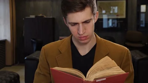 Studying a book in the library 스톡 동영상 155963058