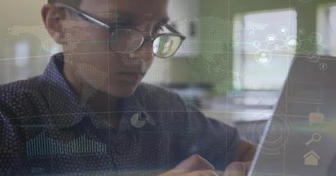 Studying child wearing patterned collared shirt tapping laptop at desk with Stock Photos