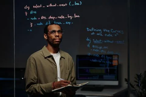 Studying Computer Code Reflected on Glass Surface 스톡 사진