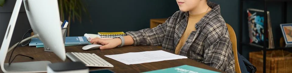 Studying at Desk with Computer Screen and Open Book Foto stock