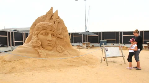 Studying the faces in the shape of sandsculptures Stock Footage 40682918