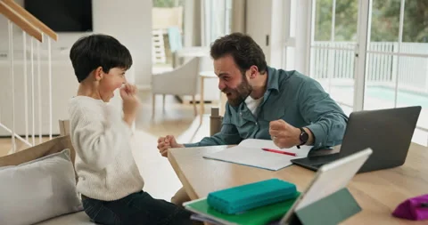 Studying, high five and father with son in family home, teaching problem solving Stock Footage 318795810