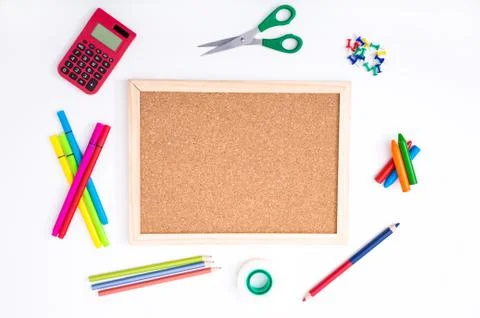 Studying at home doing homework, with a cork board background. Foto stock