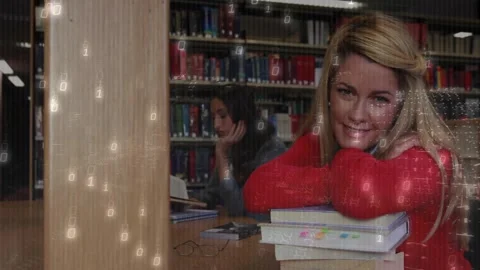 Studying in library, students with binary code animation in background Stock Footage 326876972