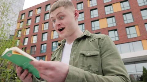 Studying in Nature A Man Puzzled by the Words He Reads Stock Footage 242951038