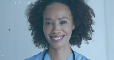 Studying nurse viewing binary medical overlay at clinic, with light blue scrubs, Foto stock