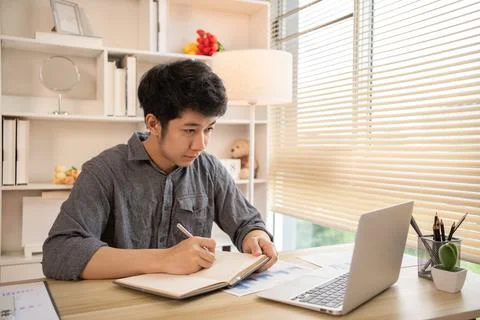 Studying online using a laptop, Man watching live video or video call of teac Stock Photos