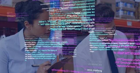 Studying partners examining code overlay on laptop screen and holding pen over Foto stock