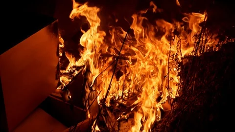 Stuff burning in a massive outdoor bonfire. Stock Footage 115098433