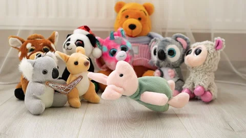 Stuffed and fluffy Pink Piglet plush toy falls on the laminate in the play area  Stock Footage 273481740