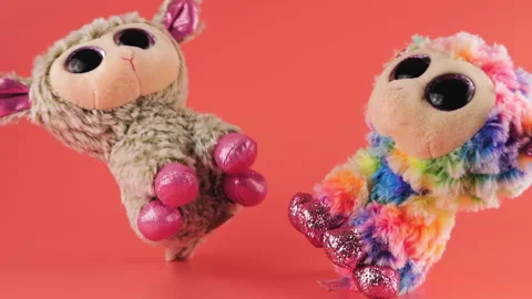 Stuffed and fluffy plush and rainbow toys sheep fall on a pink background. Slow  Stock-Footage 273485332