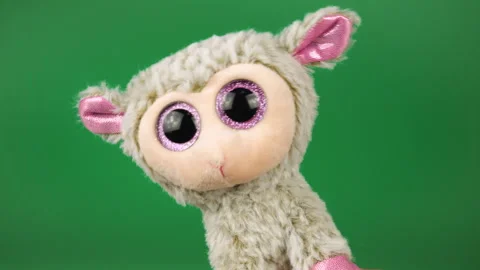 Stuffed and fluffy plush toy sheep playing and dancing on a green background. Stock Footage 272681909