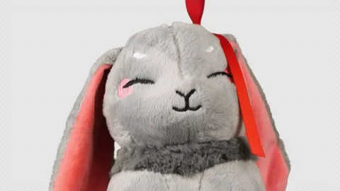 Stuffed and fluffy toy gray rabbit turns and looks around. Alpha channel include Stock Footage 276832428