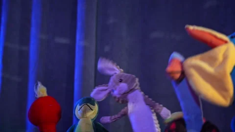 Stuffed animals dancing on stage in purple light Stock Footage 327143119
