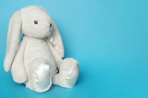 Stuffed bunny on blue background. Easter concept Stock Photos
