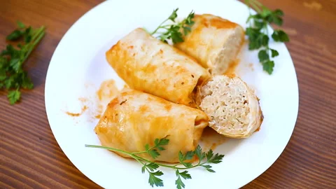 Stuffed cabbage leaves with minced meat and rice in tomato sauce. Stock Footage 106747778