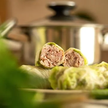 Stuffed cabbage rolls with meat. Raw or uncooked cabbage rolls cut in half Stock Photos
