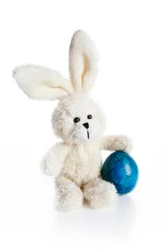 Stuffed easter bunny with blue egg Stock Photos