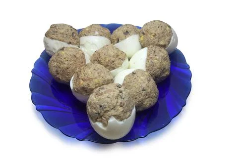 Stuffed egg halves, arranged in triangle shape, on glass semitransparent bl.. Stock Photos