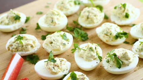 Stuffed eggs, deviled eggs on a wooden table 스톡 동영상 273509625