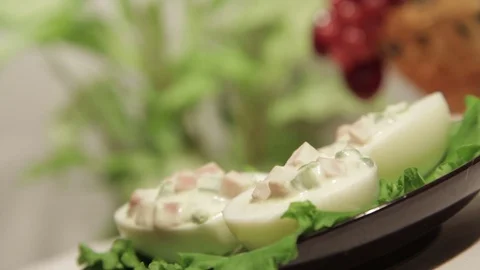 Stuffed eggs with ham, bell pepper and green onion Stock Footage 70732875