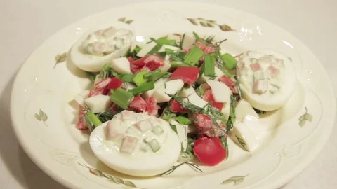 Stuffed eggs with ham, bell pepper and green onion Stock Footage 70732994