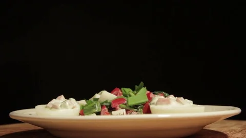 Stuffed eggs with ham, bell pepper and green onion Stock Footage 70734323