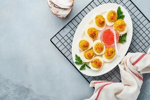 Stuffed eggs with red caviar and paprika on plate for appetizer easter table, Stock Photos