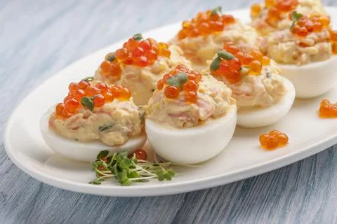 Stuffed eggs with red caviar. Stock Photos