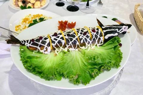 Stuffed fish on a platter. Table setting Stock Photos