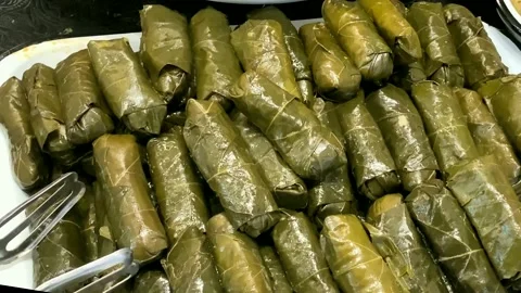 Stuffed grape leaves on the counter of the store Stock Footage 145428541