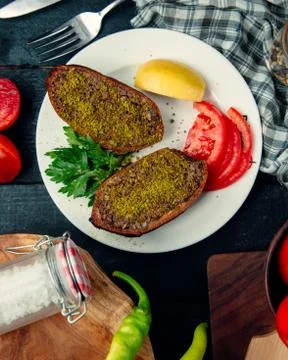 Stuffed meat cotlet cutted half served with lemon and tomato Stock Photos