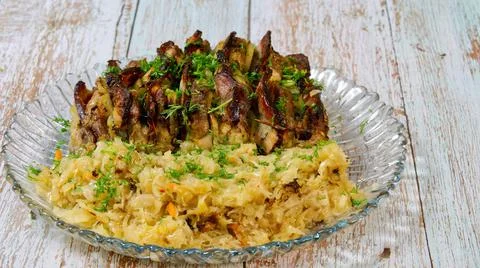 Stuffed meat with fried cabbage on a platter. Stock Photos