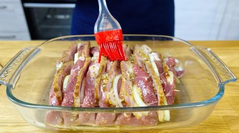 Stuffed meat oiling before baking in the oven Foto stock