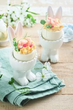 Stuffed or deviled eggs with yolk, shrimp, pea microgreens with paprika in ra Stock Photos