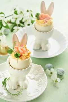 Stuffed or deviled eggs with yolk, shrimp, pea microgreens with paprika in .. 스톡 사진