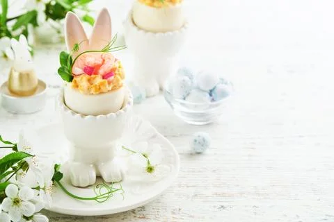 Stuffed or deviled eggs with yolk, shrimp, pea microgreens with paprika in ra Stock Photos