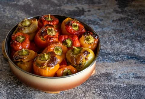 Stuffed paprika with minced meat roasted in round baking dish. Stone copy space Stock Photos