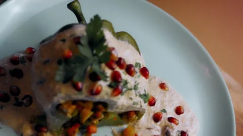 The stuffed pepper is cut to display its filling, Chiles Poblanos Video stock 331637349