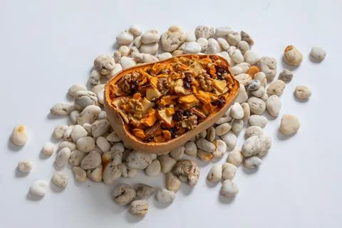 Stuffed pumpkin with nuts and dried fruits. Stock Photos