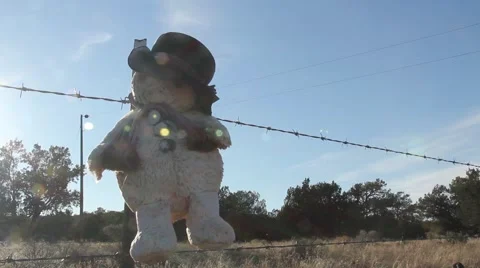 Stuffed Snowman on a Fence Stock Footage 42000694