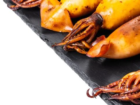 Stuffed squid on a black board Foto stock