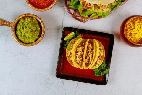 Stuffed taco shells, salsa and guacamole, mexican dish tacos. Stock Photos